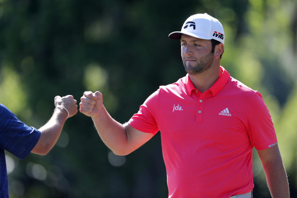 Jon Rahm, right, celebrates with teammate Ryan Palmer offer squeaking out a par on the 15th green during the final round of the PGA Zurich Classic golf tournament at TPC Louisiana in Avondale, La., Sunday, April 28, 2019. (AP Photo/Gerald Herbert)