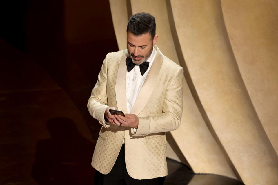 Host Jimmy Kimmel reads an online post from former President Donald Trump during the 96th Annual Academy Awards on Sunday night. Getty Images