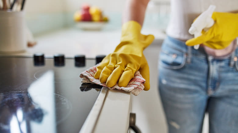 Woman cleaning stovetop