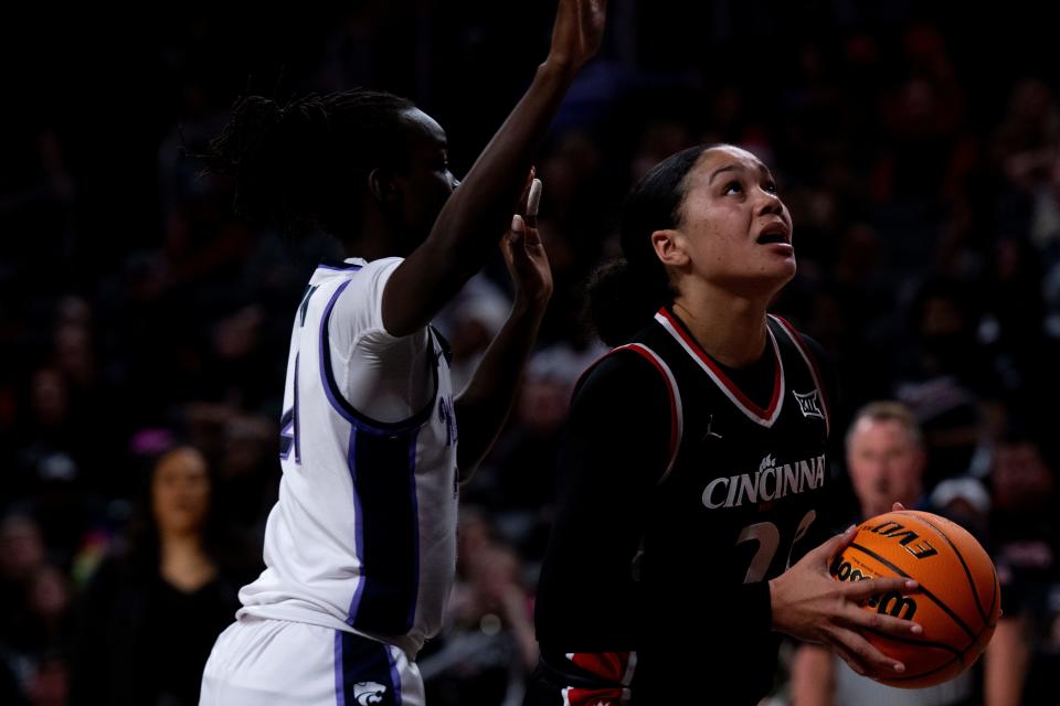 Cincinnati Bearcats forward Jillian Hayes (20) handles the ball as Kansas State Wildcats forward Eliza Maupin (21) guards her in the fourth quarter of the NCAA basketball game between Cincinnati Bearcats and Kansas State Wildcats at Fifth Third Arena in Cincinnati on Saturday, Dec. 30, 2023.