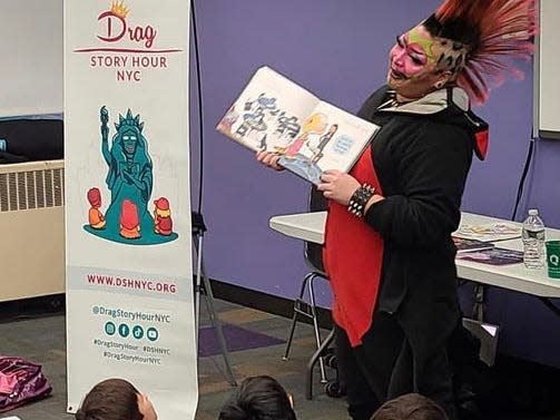 Drag king Oliver H reads to children at a Drag Story Hour in Queens, NY on December 12, 2022.