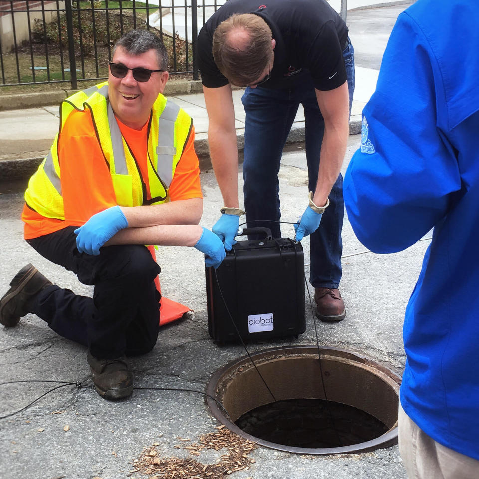 In this undated photo provided by Biobot in June 2020 technicians take a sewage sample. Across the U.S. and in Europe, researchers and health officials say they can track the course of a community outbreak by studying the waste flushed from its bathrooms. And that can provide a valuable addition to public health tools, they say. (Biobot via AP)