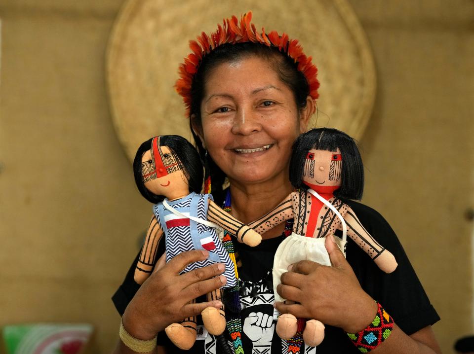 Luakam Anambe, of Brazil’s Anambé indigenous group, who is at the helm of a small, burgeoning business selling handmade indigenous dolls poses for a photo in her sewing workshop at her home in Rio de Janeiro, Brazil, Tuesday, May 24, 2022. Part of the money she makes from her dolls goes toward a social project Luakam has been putting together in Para state, to help women in need.  (AP Photo/Silvia Izquierdo) ORG XMIT: XSI113