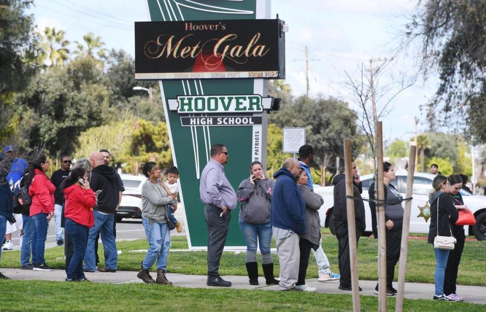 Concerned parents line up outside Herbert Hoover High School to retrieve their children after the emergency was declared a hoax Friday around noon, March 24, 2023 in Fresno.