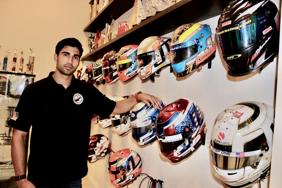 Race car driver Juan Manuel Correa with some of his helmets in his family's home in South Miami-Dade County.