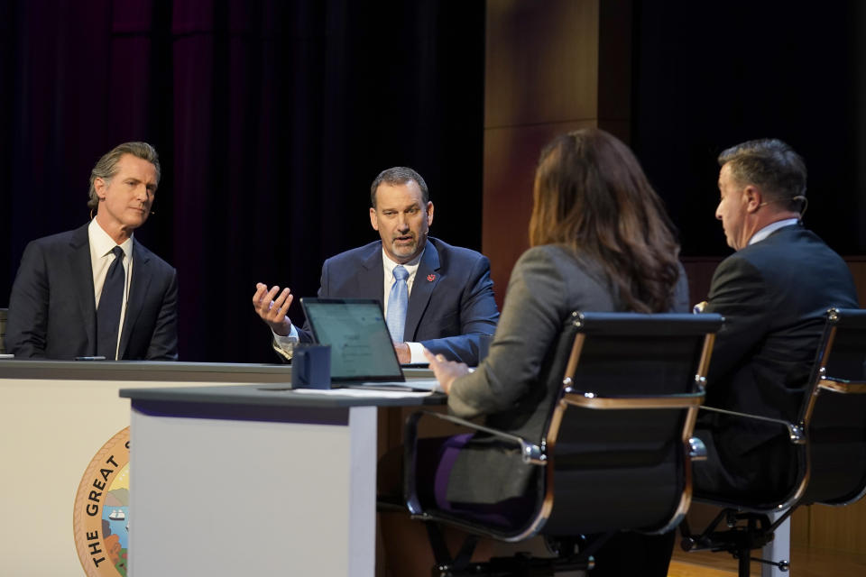 Republican gubernatorial candidate state Sen. Brian Dahle, second from left, responds to a question during a debate with Democratic Gov. Gavin Newsom, left, held by KQED Public Television in San Francisco on Sunday, Oct. 23, 2022. Also seen are debate moderators Marisa Lagos, second from right, and Scott Shafer, right. (AP Photo/Rich Pedroncelli, Pool)