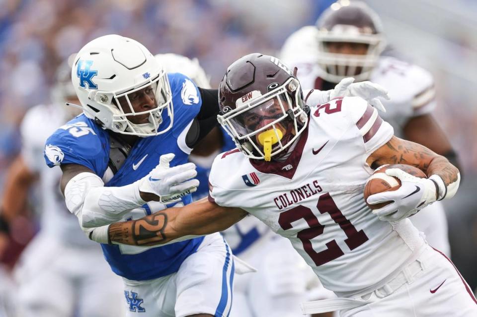 Eastern Kentucky running back Braedon Sloan (21) runs past Kentucky defensive back Jordan Lovett during Saturday’s game at Kroger Field.