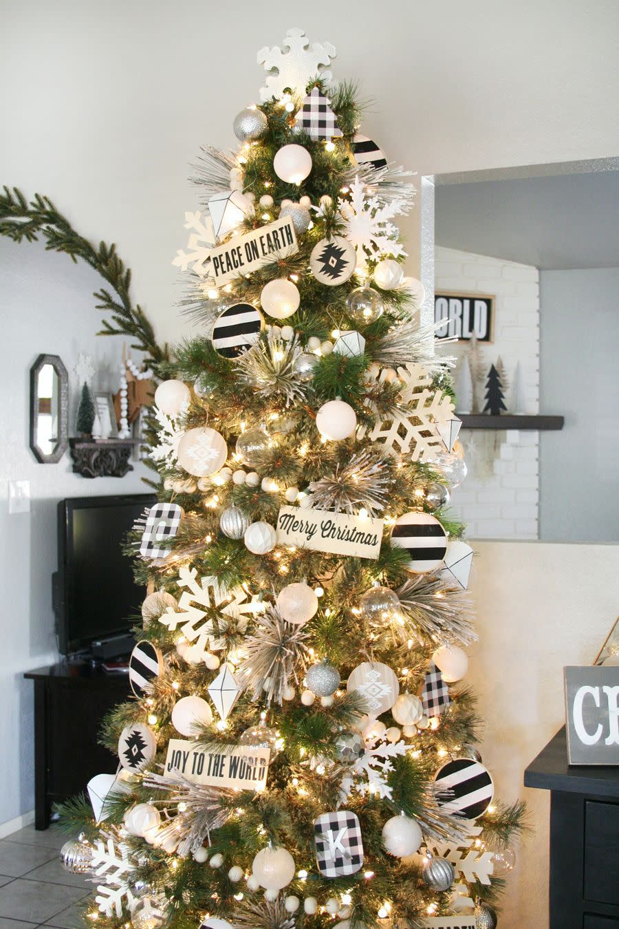 <p>Make a black-and-white tree feel perfect for your <a href="https://www.countryliving.com/home-design/decorating-ideas/g24561200/rustic-christmas-trees/" rel="nofollow noopener" target="_blank" data-ylk="slk:country chic home;elm:context_link;itc:0;sec:content-canvas" class="link ">country chic home</a> with warm white lights, gingham accents, rustic signage, and wooden snowflakes. </p><p><strong>Get the tutorial at <a href="https://www.thecraftedsparrow.com/2015/12/black-white-christmas-tree-decor.html" rel="nofollow noopener" target="_blank" data-ylk="slk:Crafted Sparrow;elm:context_link;itc:0;sec:content-canvas" class="link ">Crafted Sparrow</a>.</strong></p><p><strong><a class="link " href="https://www.amazon.com/LIDORE-Christmas-Lights-Decoration-Connection/dp/B00MHOBWYK/?tag=syn-yahoo-20&ascsubtag=%5Bartid%7C10050.g.1251%5Bsrc%7Cyahoo-us" rel="nofollow noopener" target="_blank" data-ylk="slk:SHOP WARM WHITE LIGHTS;elm:context_link;itc:0;sec:content-canvas">SHOP WARM WHITE LIGHTS</a><br></strong></p>