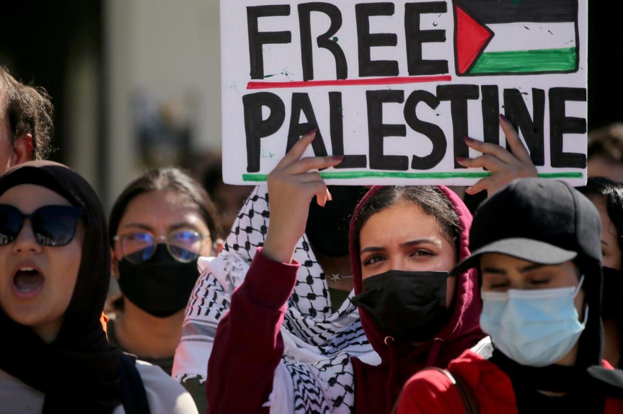 Students hold a sign reading "Free Palestine."