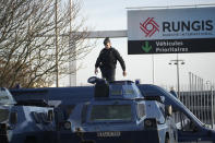 A gendarme stands atop a military vehicle at the entrance of the Rungis International Market, which supplies the capital and surrounding region with much of its fresh food, Monday, Jan. 29, 2024 south of Paris. Protesting farmers intended to encircle Paris with barricades of tractors, aiming to lay siege to France's seat of power in a battle with the government over the future of their industry shaken by the repercussions of the Ukraine war. (AP Photo/Christophe Ena)