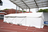 A tent is prepared to become a player changing room as Ceres Park Football Stadium gets ready for the Danish Superliga soccer match between AGF and Randers FC in Aarhus, Denmark, Wednesday May 27, 2020. FC Midtjylland and AGF Aarhus have gotten creative as they look to generate some atmosphere because games have to be played in empty stadiums. Midtjylland is planning a “drive-in” where about 2,000 supporters can watch games from inside their cars in a parking lot outside the team’s stadium. Aarhus is installing three giant screens along one side of the field displaying the faces of about 10,000 fans on a live video call. The first match of the Danish Superliga will be played Thursday evening May 28 in Aarhus. (Henning Bagger/Ritzau scanpix via AP)