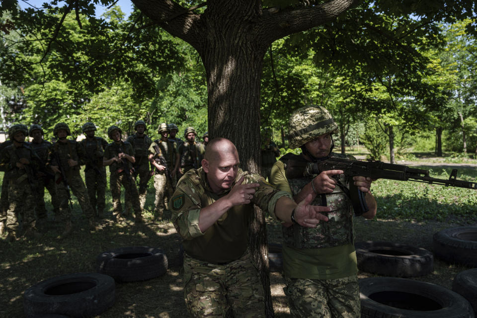 A Ukrainian military instructor of Arey Battalion trains a convict prisoner which join Ukrainian army to use a weapon at the polygon, in the Dnipropetrovsk region, Ukraine, Saturday, June 22, 2024. Ukraine is expanding its military recruiting to cope with battlefield shortages more than two years into fighting Russia’s full-scale invasion. (AP Photo/Evgeniy Maloletka)