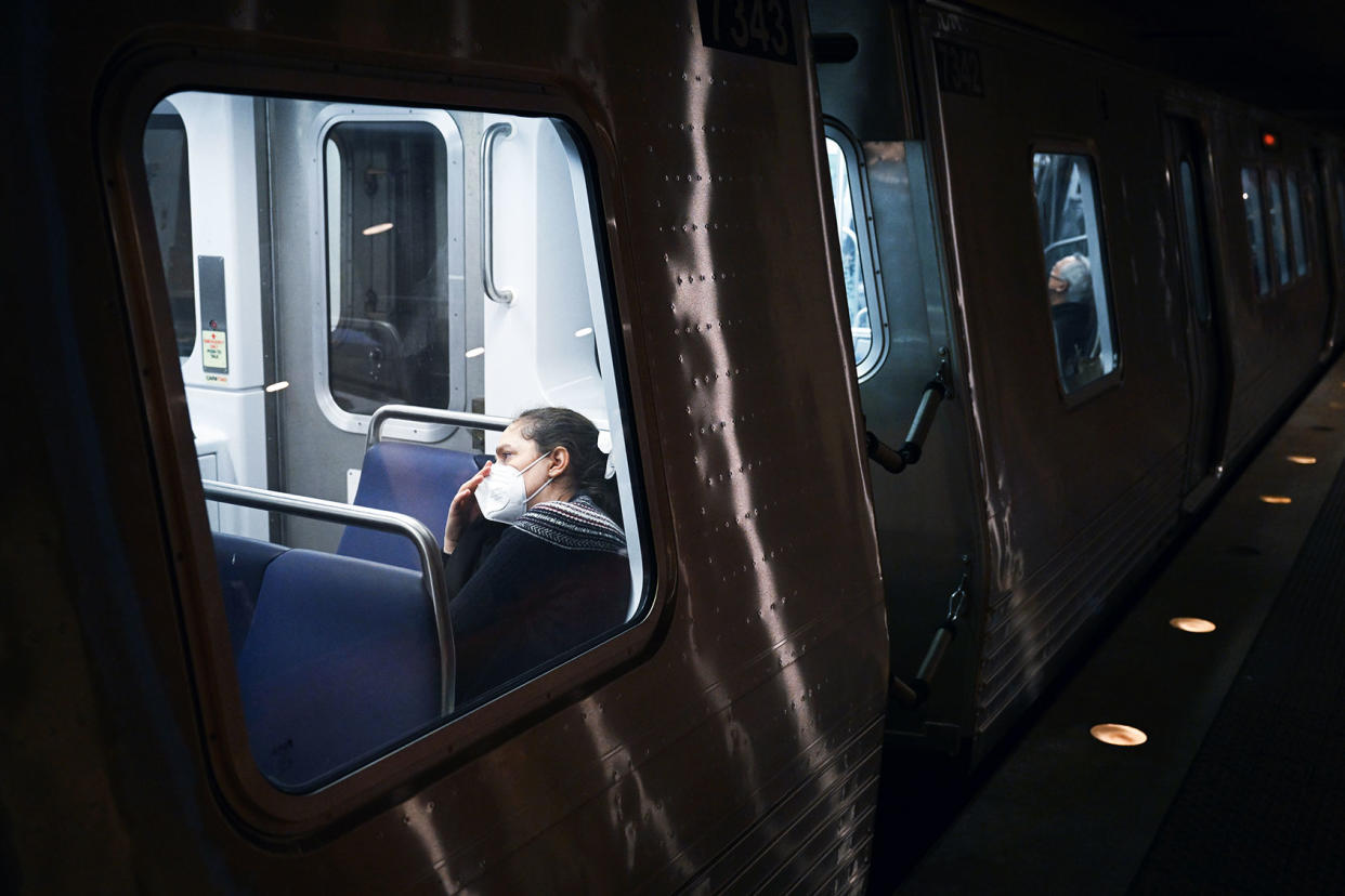 passenger wears a mask while riding metro train Matt McClain/The Washington Post via Getty Images