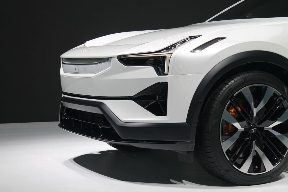 The front of the white Polestar 3 electric SUV, against a black background.