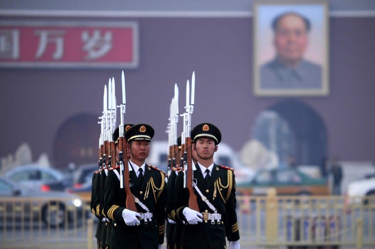 Honor guards are seen marching during a daily flag-lowering ceremony in Beijing, on March 6, 2013. China's newly-installed president Xi Jinping has close ties to the country's expanding military and on Sunday called for the armed forces to strengthen their ability to "win battles."