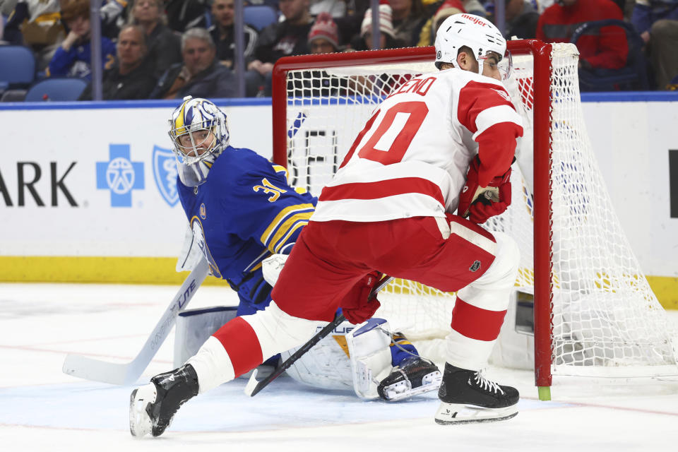 Buffalo Sabres goaltender Eric Comrie (31) stops Detroit Red Wings center Joe Veleno (90) during the second period of an NHL hockey game Tuesday, Dec. 5, 2023, in Buffalo, N.Y. (AP Photo/Jeffrey T. Barnes)