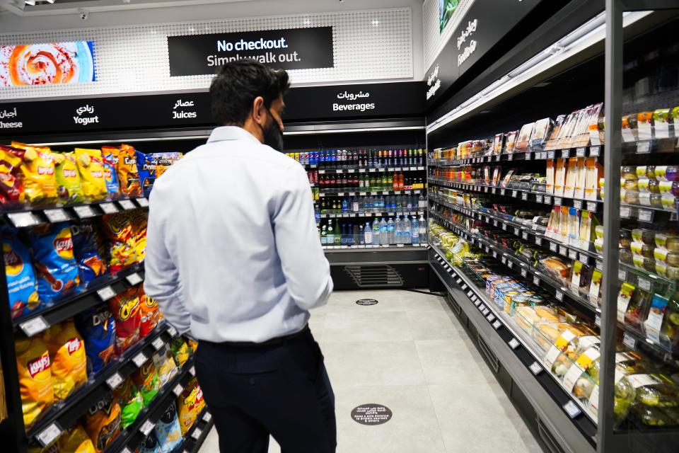 A Carrefour employee walks through Carrefour's new cashier-less grocery store in Mall of the Emirates in Dubai, United Arab Emirates, Monday, Sept. 6, 2021. The Middle East on Monday got its first completely automated cashier-less store, as retail giant Carrefour rolled out its vision for the future of the industry in a cavernous Dubai mall. (AP Photo/Isabel DeBre)