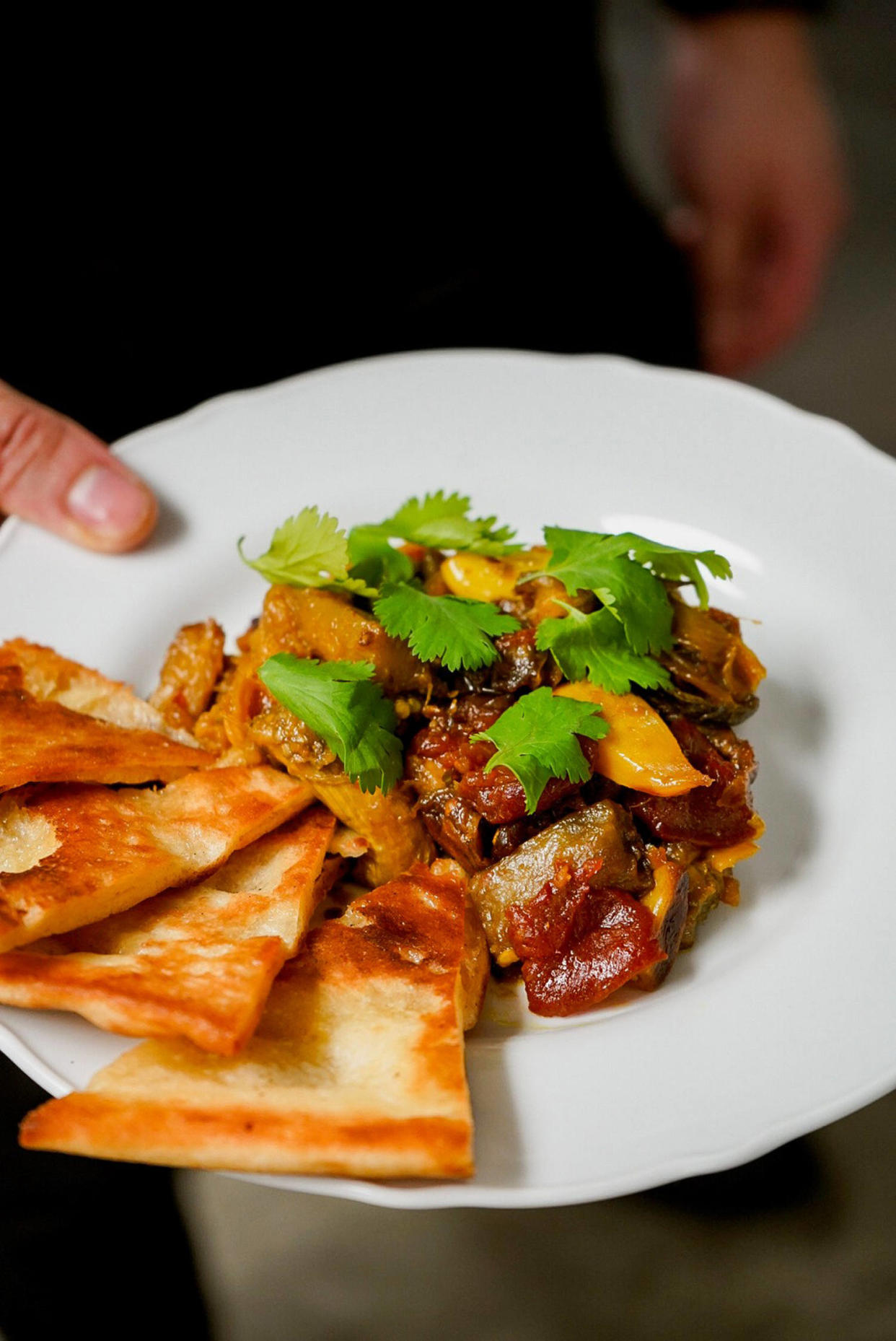 Roasted spiced eggplant served with toasted flatbread. (Manaal Shareh)