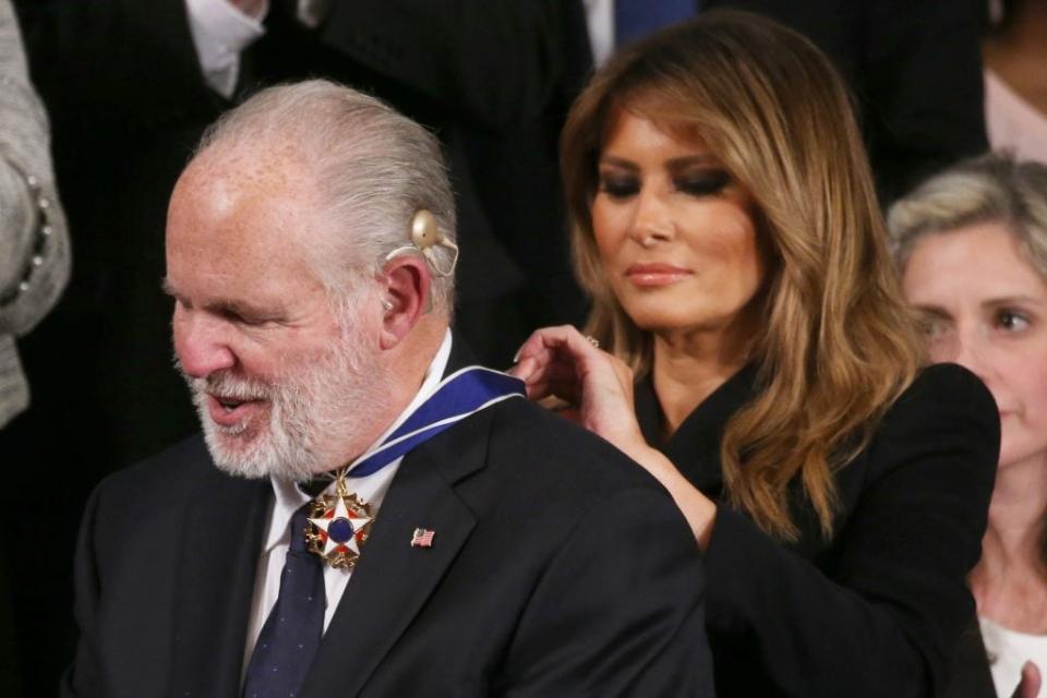 Radio personality Rush Limbaugh reacts as First Lady <span class="caas-xray-inline-tooltip"><span class="caas-xray-inline caas-xray-entity caas-xray-pill rapid-nonanchor-lt" data-entity-id="Melania_Trump" data-ylk="cid:Melania_Trump;pos:3;elmt:wiki;sec:pill-inline-entity;elm:pill-inline-text;itc:1;cat:OfficeHolder;" tabindex="0" aria-haspopup="dialog"><a href="https://search.yahoo.com/search?p=Melania%20Trump" data-i13n="cid:Melania_Trump;pos:3;elmt:wiki;sec:pill-inline-entity;elm:pill-inline-text;itc:1;cat:OfficeHolder;" tabindex="-1" data-ylk="slk:Melania Trump;cid:Melania_Trump;pos:3;elmt:wiki;sec:pill-inline-entity;elm:pill-inline-text;itc:1;cat:OfficeHolder;" class="link ">Melania Trump</a></span></span> gives him the Presidential Medal of Freedom during the State of the Union address in the chamber of the U.S. House of Representatives on February 04, 2020 in Washington, DC. President Trump delivers his third State of the Union to the nation the night before the U.S. Senate is set to vote in his impeachment trial. (Photo by Mario Tama/Getty Images)