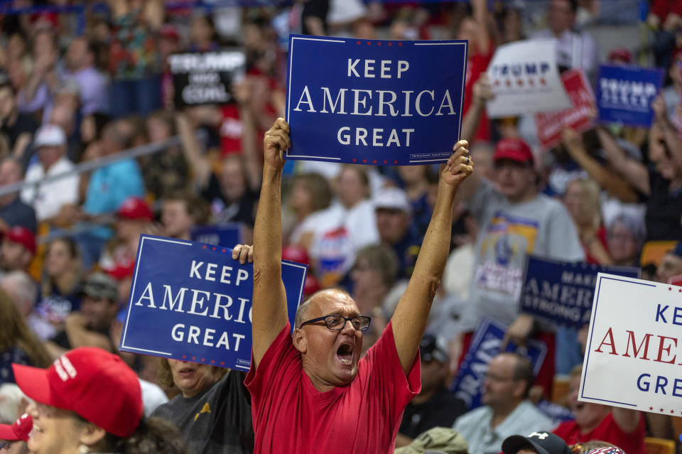 A supporter holds a sign aloft before President Trump takes the stage at a rally in support of the Senate candidacy of Attorney General Patrick Morrisey, Tuesday, Aug. 21, 2018, at the Charleston Civic Center in Charleston, W.Va. (Craig Hudson/Charleston Gazette-Mail via AP)