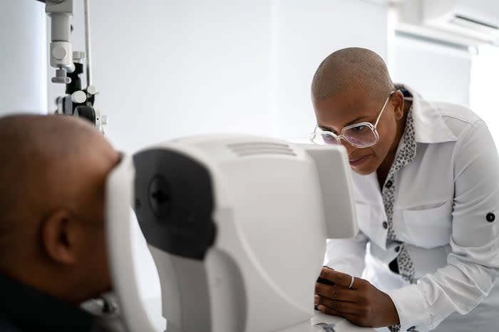 Person getting their eyes scanned by tech.