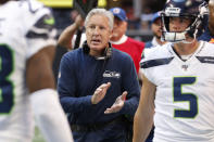 Seattle Seahawks head coach Pete Carroll speaks with players after a Seattle Seahawks field goal against the Atlanta Falcons during the first half of an NFL football game, Sunday, Oct. 27, 2019, in Atlanta. (AP Photo/John Bazemore)