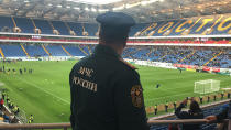 FILE - In this file photo released by Russian Emergency Situations Ministry on April 28, 2018, a Russian Emergencies Ministry officer attends a training session to ensure security at the World Cup during drills at the World Cup stadium in Rostov-on-Don, Russia. A year after hosting the World Cup, Russia is boasting the biggest club soccer crowds since Soviet days and participation at the amateur level is on the rise. Still, there are signs of trouble for the sport. (Russian Ministry for Emergency Situations photo via AP, File)