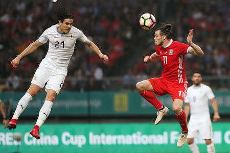 Football Soccer - Wales v Uruguay - China Cup Finals - Guangxi Sports Center, Nanning, China - March 26, 2018. Edinson Cavani of Uruguay and Gareth Bale of Wales in action. REUTERS/Stringer