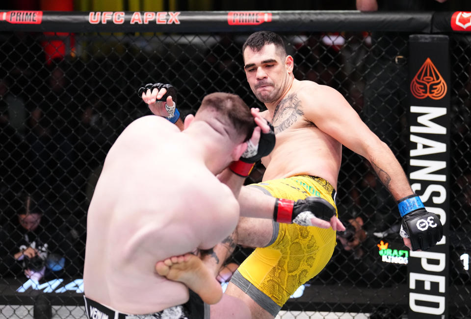 LAS VEGAS, NEVADA – NOVEMBER 18: (R-L) Caio Machado of Brazil kicks Mick Parkin of England in a heavyweight fight during the UFC Fight Night event at UFC APEX on November 18, 2023 in Las Vegas, Nevada. (Photo by Chris Unger/Zuffa LLC via Getty Images)