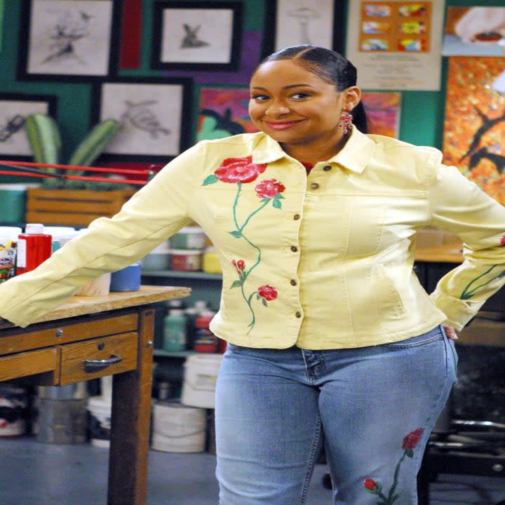 Raven-Symoné smiling in an art studio