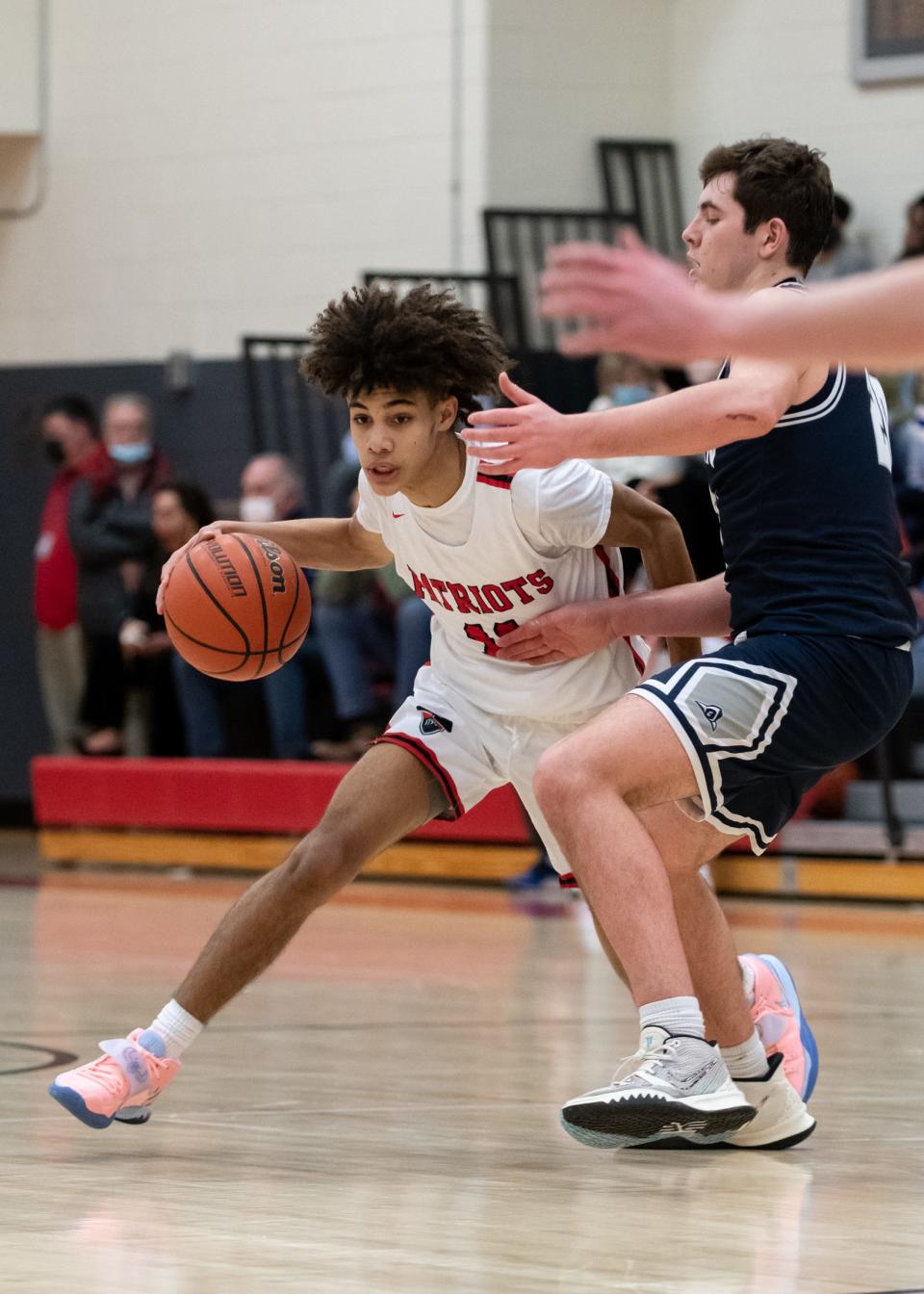 Germantown Academy's Bryce Rollerson dribbles past Malvern Prep's Andrew Phillips, on Friday, January 14, 2022, at Germantown Academy in Fort Washington. The Friars upended the Patriots 69-42.