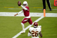 Arizona Cardinals quarterback Kyler Murray (1) scores a touchdown as Washington Football Team strong safety Landon Collins (26) looks on during the first half of an NFL football game, Sunday, Sept. 20, 2020, in Glendale, Ariz. (AP Photo/Ross D. Franklin)