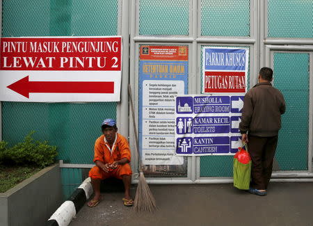 A man stands in front of the visitors' gate of Cipinang prison in Jakarta, January 17, 2016. REUTERS/Beawiharta