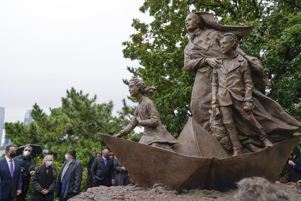 New York Gov. Andrew Cuomo, left, attends a ceremony unveil the statue of the patron saint of immigrants, Mother Frances Cabrini, in Battery Park Monday, Oct. 12, 2020, in New York. (AP Photo/Frank Franklin II)