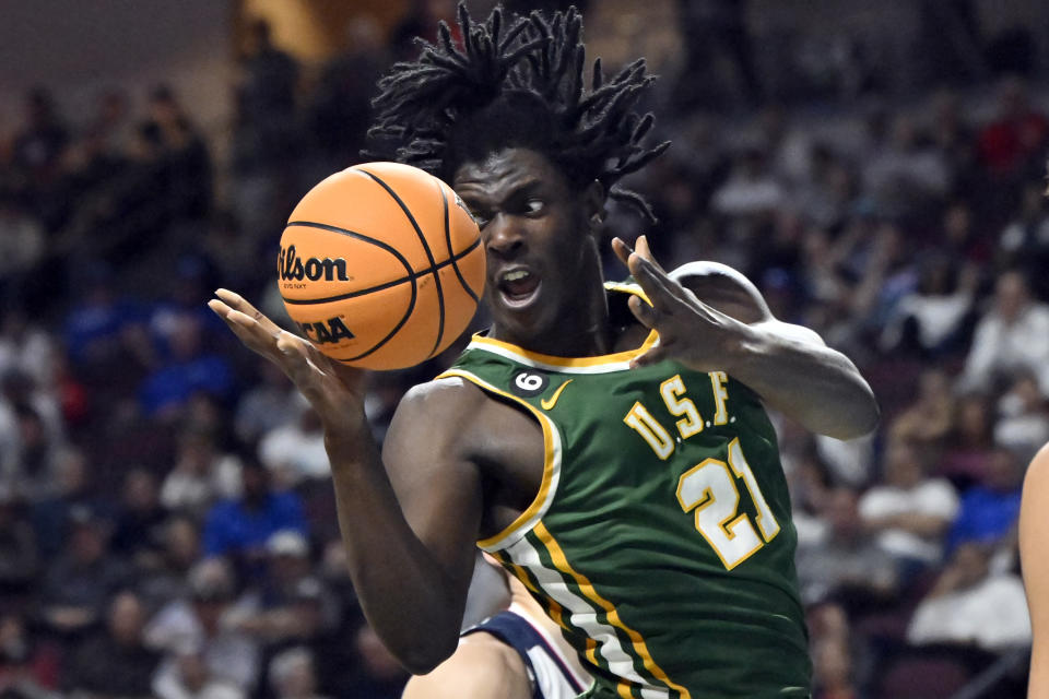 San Francisco forward Ndewedo Newbury (21) goes to grab the ball against Gonzaga during the first half of an NCAA college basketball game in the semifinals of the West Coast Conference men's tournament Monday, March 6, 2023, in Las Vegas. (AP Photo/David Becker)