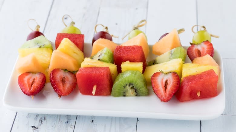 Fruit skewers on white plate