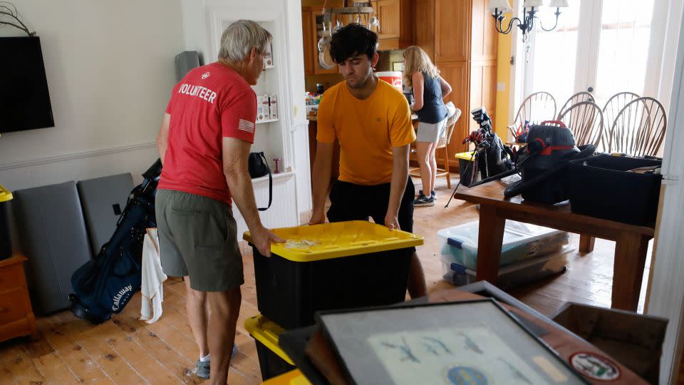 Rich Lorenzen and his son Sam Grande carry their belongings as they prepare to evacuate their home before the arrival of Hurricane Milton, St. Pete Beach, Florida, on October 7. - Octavio Jones/Reuters