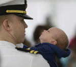 Six-week old Ewan Bingham, takes a look at his dad, Lt. Chris Bingham, of Cranford, N.J., after Chris disembarked from the nuclear aircraft carrier Harry S. Truman at Naval Station Norfolk in Norfolk, Va., Friday, April 18, 2014. The carrier strike group is returning from a 9-month deployment. There were 171 babies born to sailors aboard the ship during the deployment, according to the Navy. (AP Photo/Steve Helber)