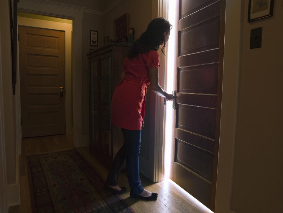 a woman shutting a door