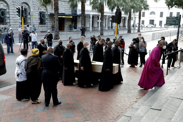 Archbishop Thabo Makgoba heads pallbearers carrying Tutu's coffin into the cathedral for the lying in state (AFP/GIANLUIGI GUERCIA)