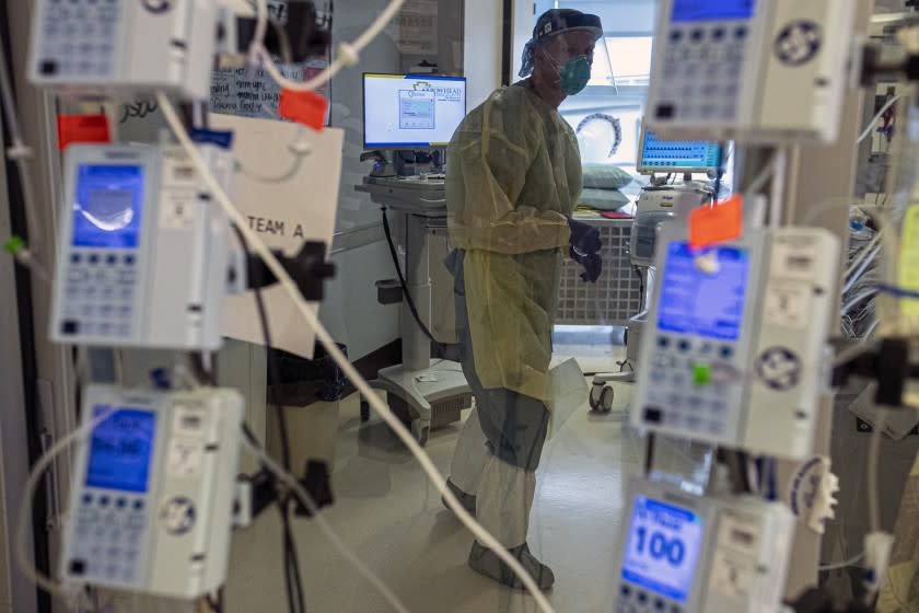 Colton, CA - December 23: A nurse Brian attends to a coronavirus patient in an Intensive Care Unit at at Arrowhead Regional Medical Center on Wednesday, Dec. 23, 2020 in Colton, CA. (Irfan Khan / Los Angeles Times)