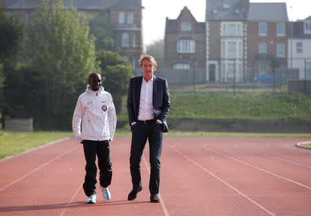 Athletics - Eliud Kipchoge reveals plans to break two hour marathon record - Iffley Road Sports Centre, Oxford, Britain May 6, 2019. Kenya's Eliud Kipchoge speaks with Sir Jim Ratcliffe REUTERS/Andrew Boyers