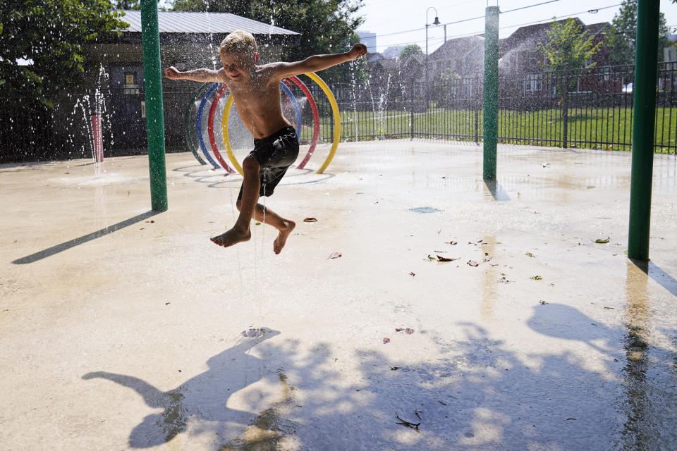 Cannon Brown, 5, runs through the water at a local park's splash pad Friday, June 30, 2023 in Nashville, Tenn. Weather forecasts call for heat indexes to reach over 105 degrees Fahrenheit for the Middle Tennessee area through the weekend. (AP Photo/George Walker IV)