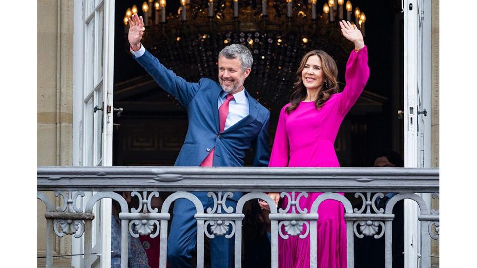 King Frederik and Queen Mary holding hands on the balcony of Amalienborg Palace