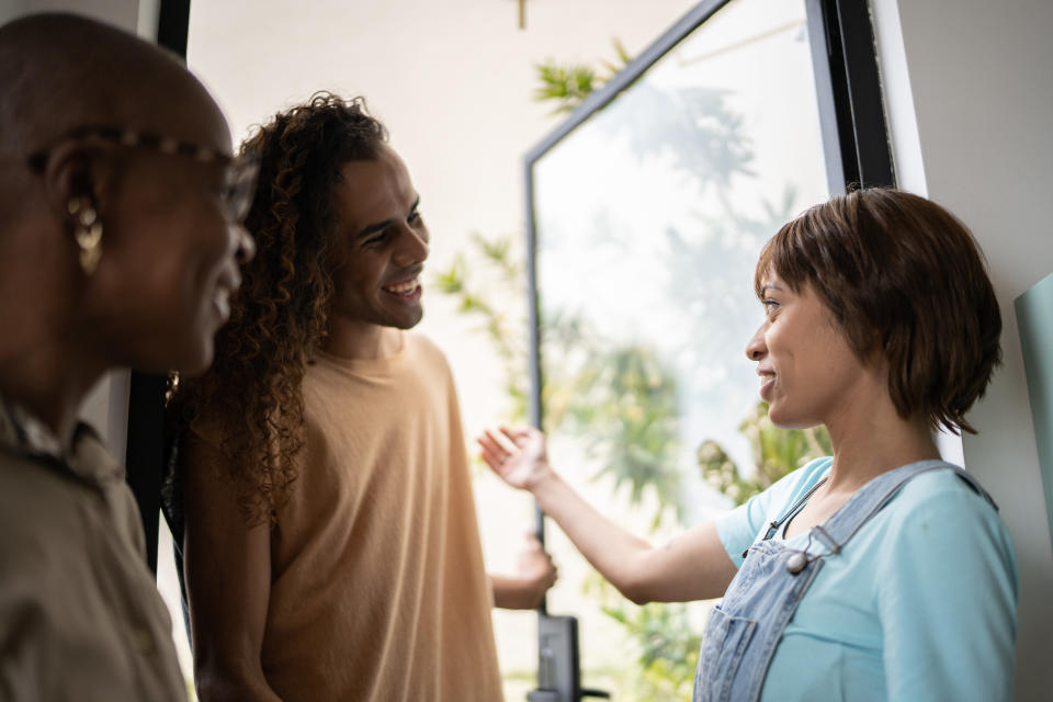 Young women welcoming friends or family at home