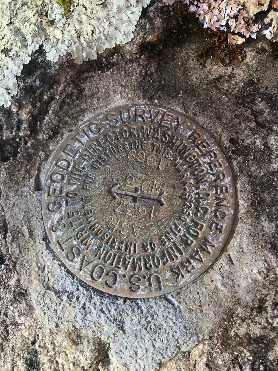 A geodetic disk embedded in a boulder marks the border with Connecticut.