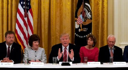 U.S. President Donald Trump meets with Senate Republicans about healthcare in the East Room of the White House in Washington, U.S., June 27, 2017. Trump is flanked by Senators Susan Collins (R-ME) and Sen. Lisa Murkowski (R-AK). REUTERS/Kevin Lamarque