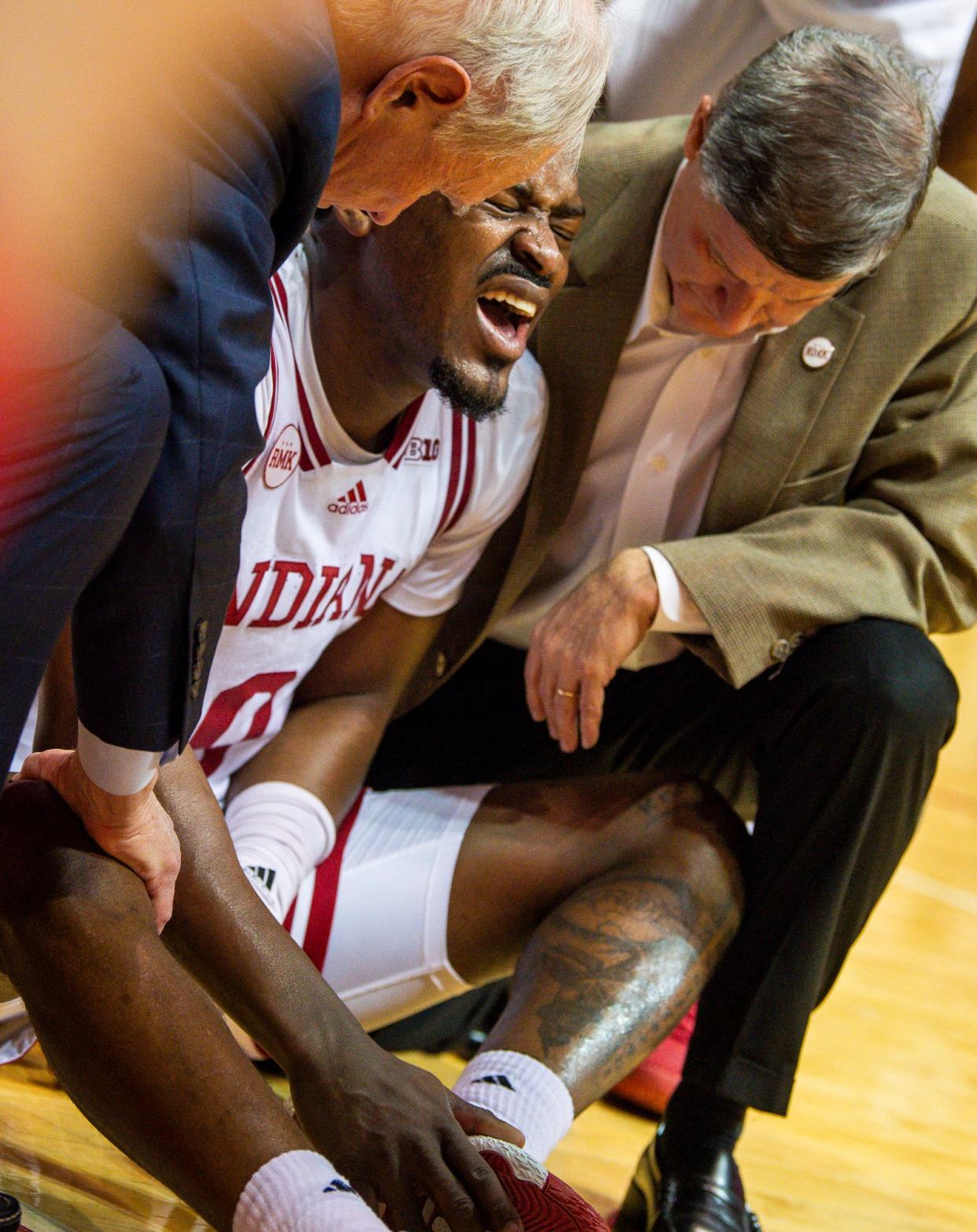Indiana's Xavier Johnson (0) winces in pain after being injured during the second half of the Indiana versus Iowa men's basketball game at Simon Skjodt Assembly Hall on Tuesday, Jan. 30, 2024.