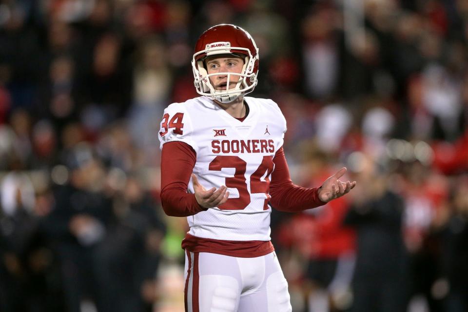 Oklahoma place-kicker Zach Schmit (34) reacts after his missed field goal in overtime against Texas Tech during an NCAA college football game Saturday, Nov. 26, 2022, in Lubbock, Texas. (Ian Maule/Tulsa World via AP)
