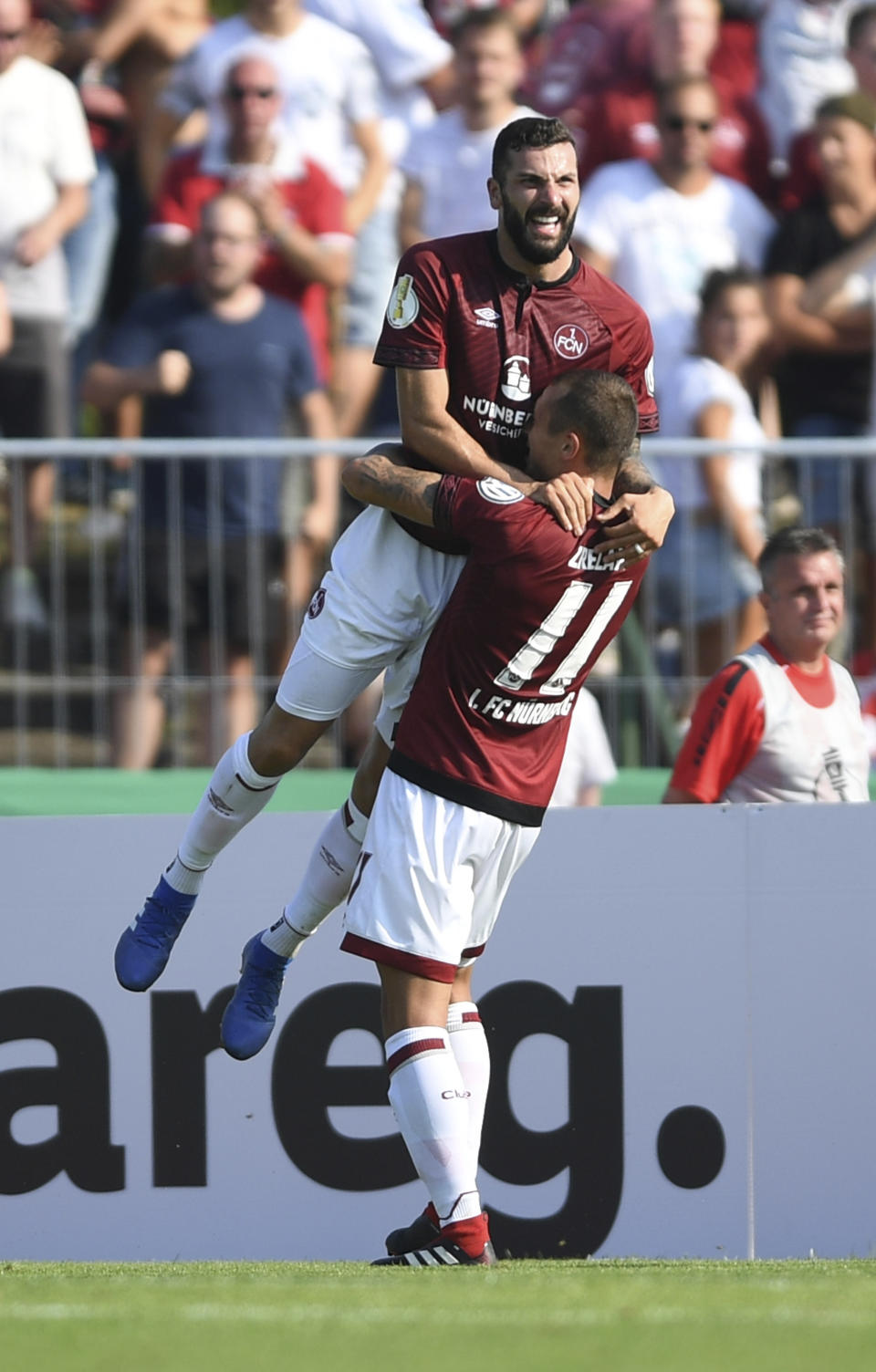 File - In this Saturday, Aug. 18, 2018 photo Nuremberg's Mikael Ishak, left, and his teammate Adam Zrelak, right, celebrate during a German soccer cup match against SV Linx in Kehl, Germany. (Patrick Seeger/dpa via AP, file)